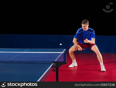 Table tennis player isolated on black