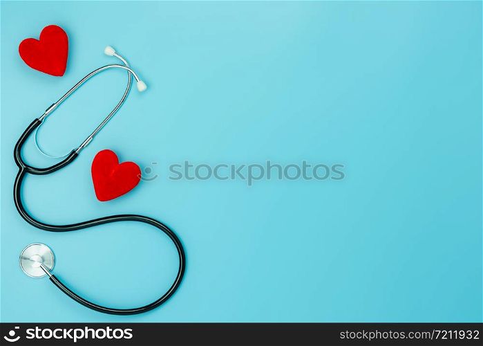 Table top view aerial image of accessories healthcare & medical with Valentines day background concept.telescope with colorful heart shape on blue paper.Flat lay items for doctor using treat patient.