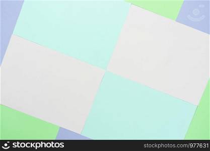 Table top view aerial image of colorful pastel paper background concept.Abstract flat lay pink blue purple and green wallpaper.