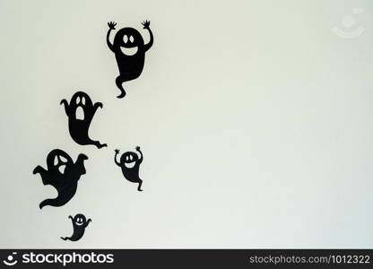 Table top view aerial image of decoration Happy Halloween day background concept.Flat lay accessories essential object to party the black ghost on rustic white stone.Space for creative design text.