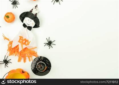 Table top view aerial image of decoration Happy Halloween day background concept.Flat lay accessories essential object to party the pumpkin & doll and candy on white wooden.Space for creative design.