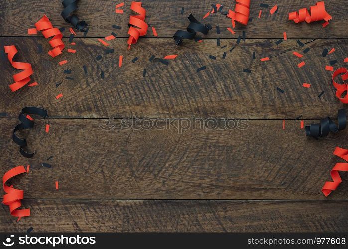 Table top view aerial image of decoration Happy Halloween day background concept.Flat lay accessories essential object to party the paper confetti on brown wooden.Space for creative design mock up.