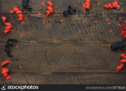 Table top view aerial image of decoration Happy Halloween day background concept.Flat lay accessories essential object to party the paper confetti on brown wooden.Space for creative design mock up.