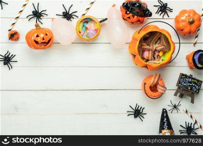 Table top view aerial image of decoration Happy Halloween day background concept.Flat lay accessories essential object to party the pumpkin & sweet candy on white wooden.Space for creative design.
