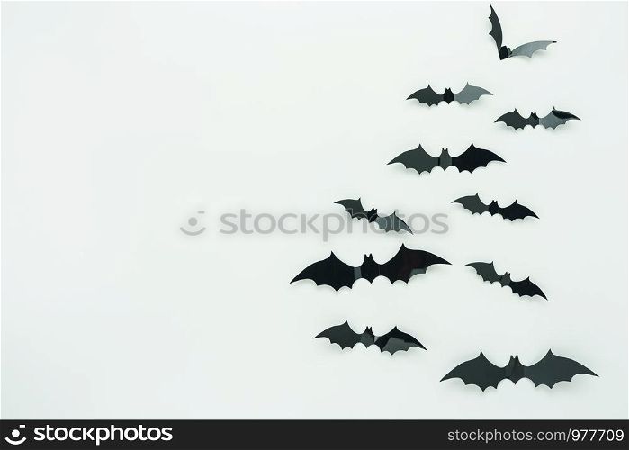 Table top view aerial image of decoration Happy Halloween day background concept.Flat lay accessories essential object to party the bat fly on white wooden wallpaper.Copy space for creative design.