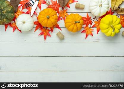 Table top view aerial image of decoration Happy Halloween or Thanksgiving day background concept.Flat lay accessory object to party the pumpkin & maple leaf on white wooden.Space for creative design.