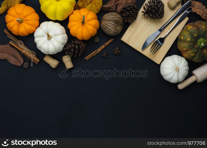 Table top view aerial image of decoration Happy Halloween or Thanksgiving day background concept.Flat lay accessory object to party the pumpkin & dinner set on black wooden.Space for creative design.