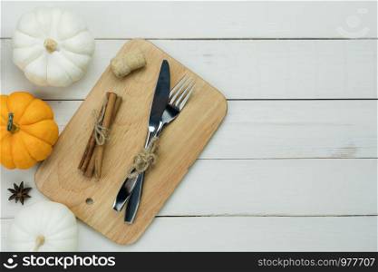 Table top view aerial image of decoration Happy Halloween or Thanksgiving day background concept.Flat lay accessory object to party the pumpkin & dinner set on white wooden.Space for creative design.