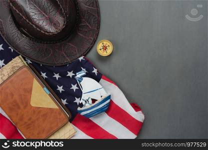 Table top view aerial image of decoration the sign of USA Happy Columbus day on Oct 8,2018 background concept.Flat lay accessories US flag and sign season on modern rustic grey wooden.Space for design