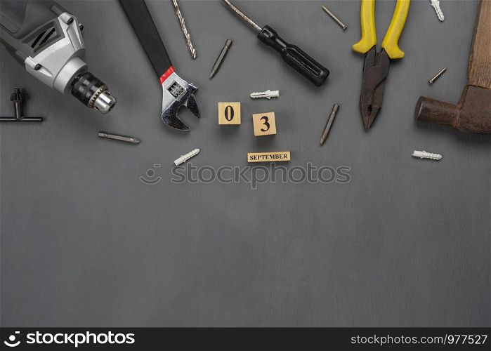 Table top view aerial image of decoration the sign of USA labor day on Sep 3,2018 background concept. Flat lay accessories US flag and essential tools worker on modern grey wooden with copy space.