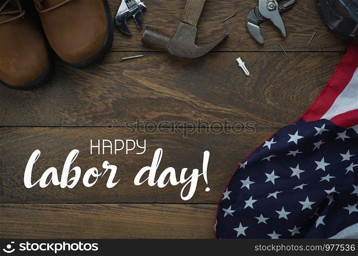 Table top view aerial image of decoration the sign of USA labor day on Sep 3,2018 background concept. Flat lay accessories US flag and essential tools worker on brown wooden with copy space and text.