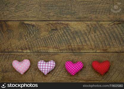Table top view aerial image of decoration valentine&rsquo;s day background concept.Flat lay essential items colorful pastel love shape on modern rustic brown wooden.blank space for mock up creative design.