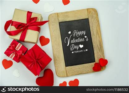 Table top view aerial image of decoration valentine&rsquo;s day background concept.Flat lay arrangement of blank space blackboard & essential items on modern rustic white wood for mock up creative design