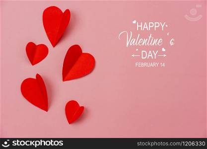 Table top view aerial image of decoration valentine&rsquo;s day background concept.Flat lay essential items colorful love shape paper cut with welcome word of season on modern rustic red wallpaper.