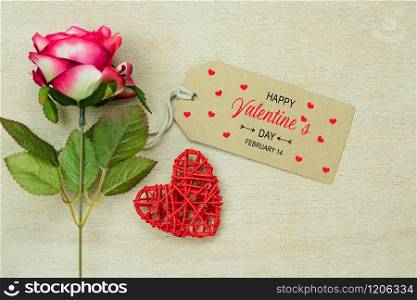 Table top view aerial image of decoration valentine&rsquo;s day background concept.Flat lay arrangement of word season tag & essential items love heart with rose flower on modern rustic white wooden.