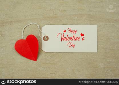 Table top view aerial image of decoration valentine&rsquo;s day background concept.Flat lay arrangement of word season tag & essential items love heart on modern rustic white wooden for mock up design.