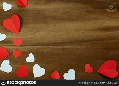 Table top view aerial image of decoration valentine&rsquo;s day background concept.Flat lay essential items colorful love shape paper cut on modern rustic brown wooden.space for mock up creative design.