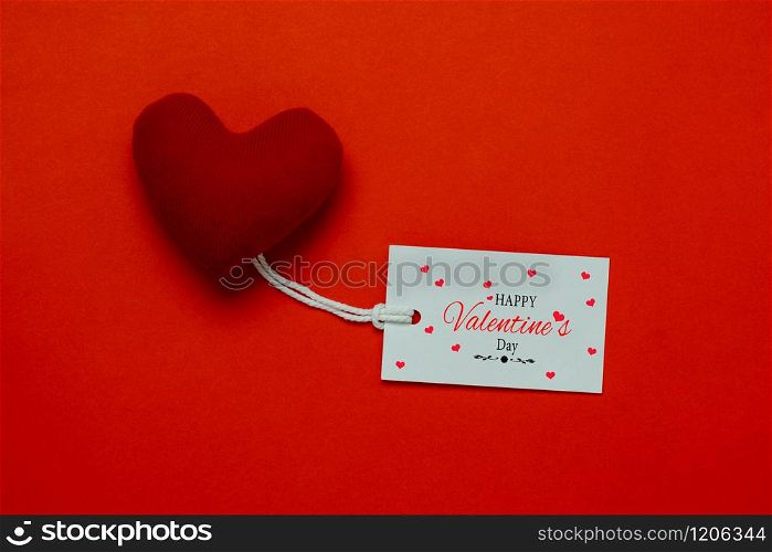Table top view aerial image of decoration valentine&rsquo;s day background concept.Flat lay arrangement of word season tag & essential items love heart on modern rustic red paper for mock up creative design