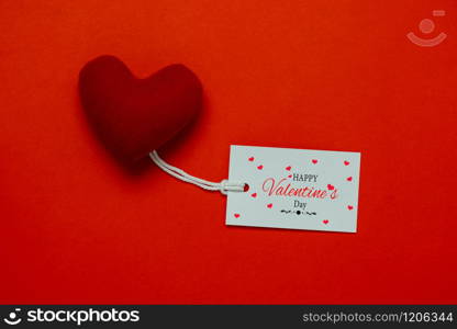 Table top view aerial image of decoration valentine&rsquo;s day background concept.Flat lay arrangement of word season tag & essential items love heart on modern rustic red paper for mock up creative design