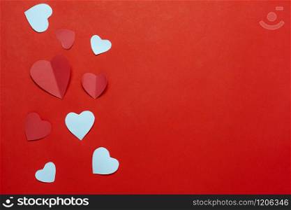 Table top view aerial image of decoration valentine&rsquo;s day background concept.Flat lay essential items colorful love shape paper cut on modern rustic red wallpaper.space for mock up creative design.