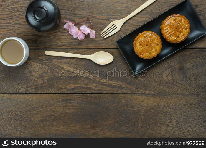 Table top view aerial image of decorations Chinese Moon Festival or lunar new year background concept.Flat lay essential meal set for coffee break of sweet cake &