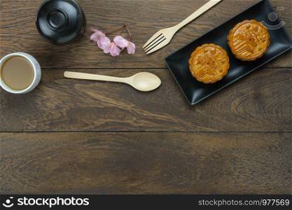 Table top view aerial image of decorations Chinese Moon Festival or lunar new year background concept.Flat lay essential meal set for coffee break of sweet cake &