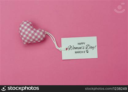 Table top view aerial image of decorations for international women&rsquo;s day holiday concept background.Flat lay sign of season the word 8 march happy woman&rsquo;s day card with heart shape on pink paper.