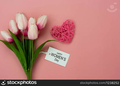 Table top view aerial image of decorations for international women&rsquo;s day holiday concept background.Flat lay sign of season the word 8 march happy woman&rsquo;s day with flower and gift box on pink paper.