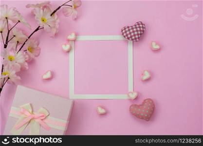 Table top view aerial image of decorations for international women&rsquo;s day holiday concept background.Flat lay sign of season the word 8 march happy woman&rsquo;s day with flower and gift box on pink paper.