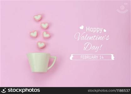 Table top view aerial image of sign valentine&rsquo;s day background concept.Flat lay arrangement white coffee cup with steam heart shape on modern pink paper at home office desk studio & text design.