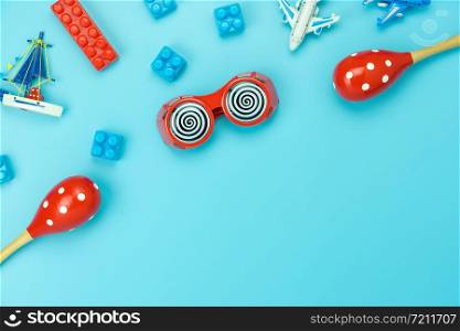 Table top view decoration kid toys for develop background concept.Flat lay accessories baby to play with items child on modern bule paper at office desk.Copy space for add text.pastel tone wallpaper.