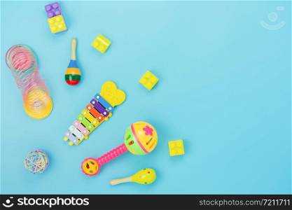 Table top view decoration kid toys for develop background concept.Flat lay accessories baby to play with items child on modern blue paper at office desk.Copy space for add text.pastel tone wallpaper.