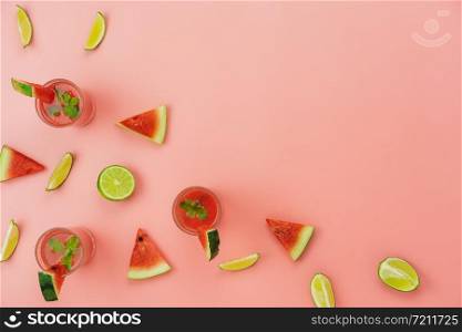 Table top view fruit tropical with drink with spring summer holiday & vacation background concept.Arrangement sliced lime with watermelon juice on modern pink paper.Copy space for design text.pastel.