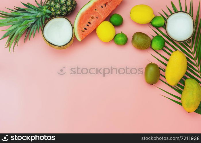 Table top view fruit tropical with spring summer holiday & vacation background concept.flat lay arrangement sliced various watermelon pineapple kiwi mango lemon and lime coconut on pink paper.