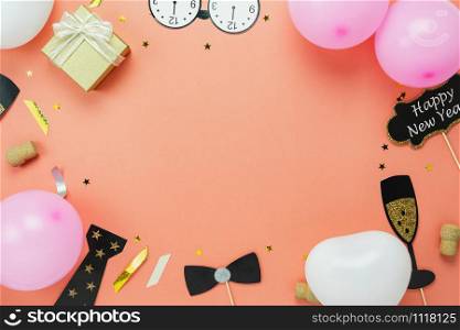 Table top view of Merry Christmas decoration & Happy new year 2019 ornament concept.Flat lay the photo booth prob and gift box & balloon with golden confetti on modern pink paper background.copy space