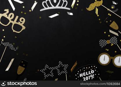 Table top view of Merry Christmas decorations & Happy new year 2019 ornaments concept.Flat lay essential difference objects to party season the photo booth prob on modern wooden black background.