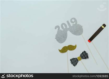 Table top view of Merry Christmas decorations & Happy new year 2019 ornaments concept.Flat lay essential difference objects to party season the photo booth prob on modern wooden white background.