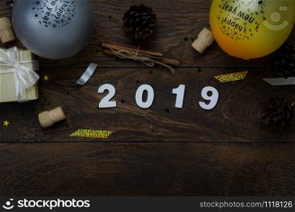 Table top view of Merry Christmas decorations & Happy new year 2019 ornaments concept.Flat lay essential difference objects to party season the photo booth prob on modern wooden brown background.