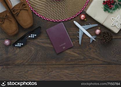 Table top view of Merry Christmas decorations & Happy new year 2019 ornaments concept.Flat lay essential difference objects to travel text & gift box with clothing on modern wooden brown background.