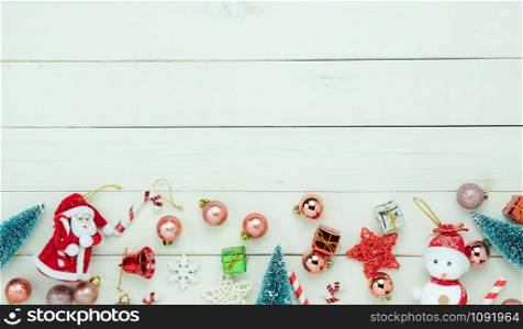 Table top view of Merry Christmas decorations & Happy new year ornaments concept.Flat lay essential difference objects decor & fir tree on modern white wooden background at home studio office desk.
