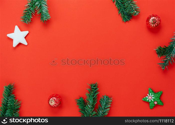 Table top view of Merry Christmas decorations & Happy new year ornaments concept.Flat lay essential objects the fir tree & gift box on modern rustic green paper background at home studio office desk.