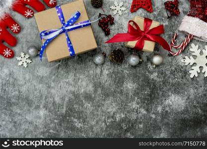 Table top view of Merry Christmas decorations & Happy new year ornaments concept.Flat lay essential difference objects gift box & fir tree on modern cement background at home studio office desk.