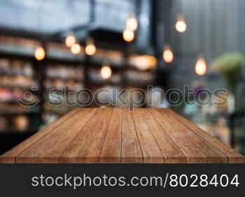 Table top wood with coffee shop blurred background with bokeh