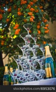 Table with glasses for champagne, cherry in glasses.