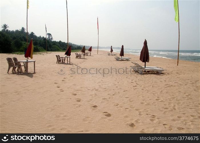 Tables and beds on the Bentota beach in Sri Lanka