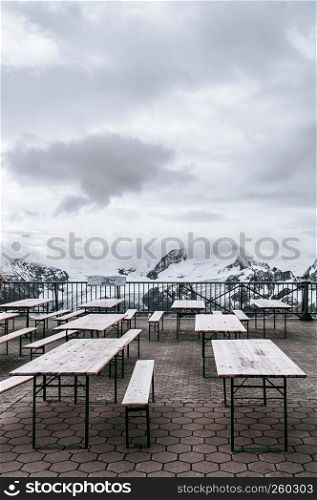 Tables and benches on mount Titlis view point, Engelberg, Switzerland. Famous tourist attraction on Swiss alps.