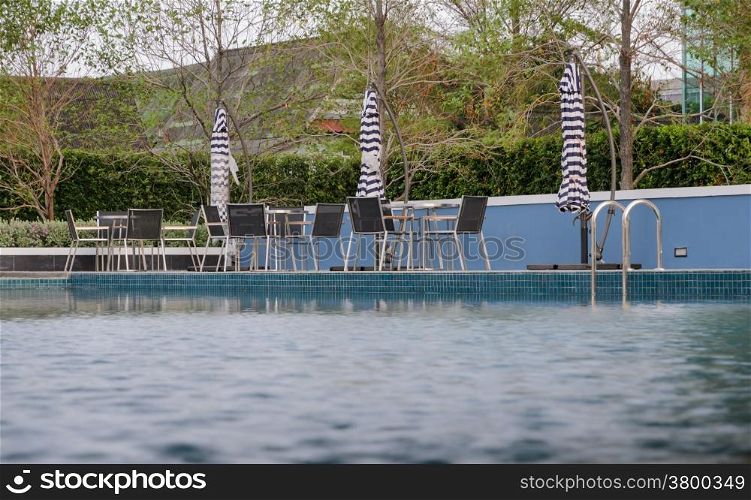 Tables and chairs at swimming pool