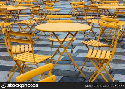 tables and chairs in a cafe on the street