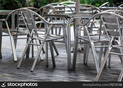 tables and chairs in a cafe on the street