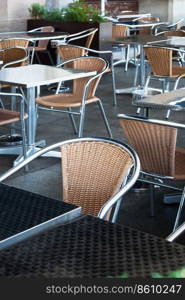 tables and chairs in a cafe on the street